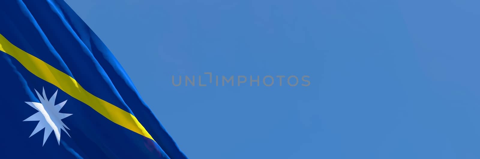 3D rendering of the national flag of Nauru waving in the wind against a blue sky