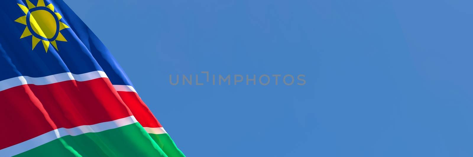 3D rendering of the national flag of Namibia waving in the wind against a blue sky