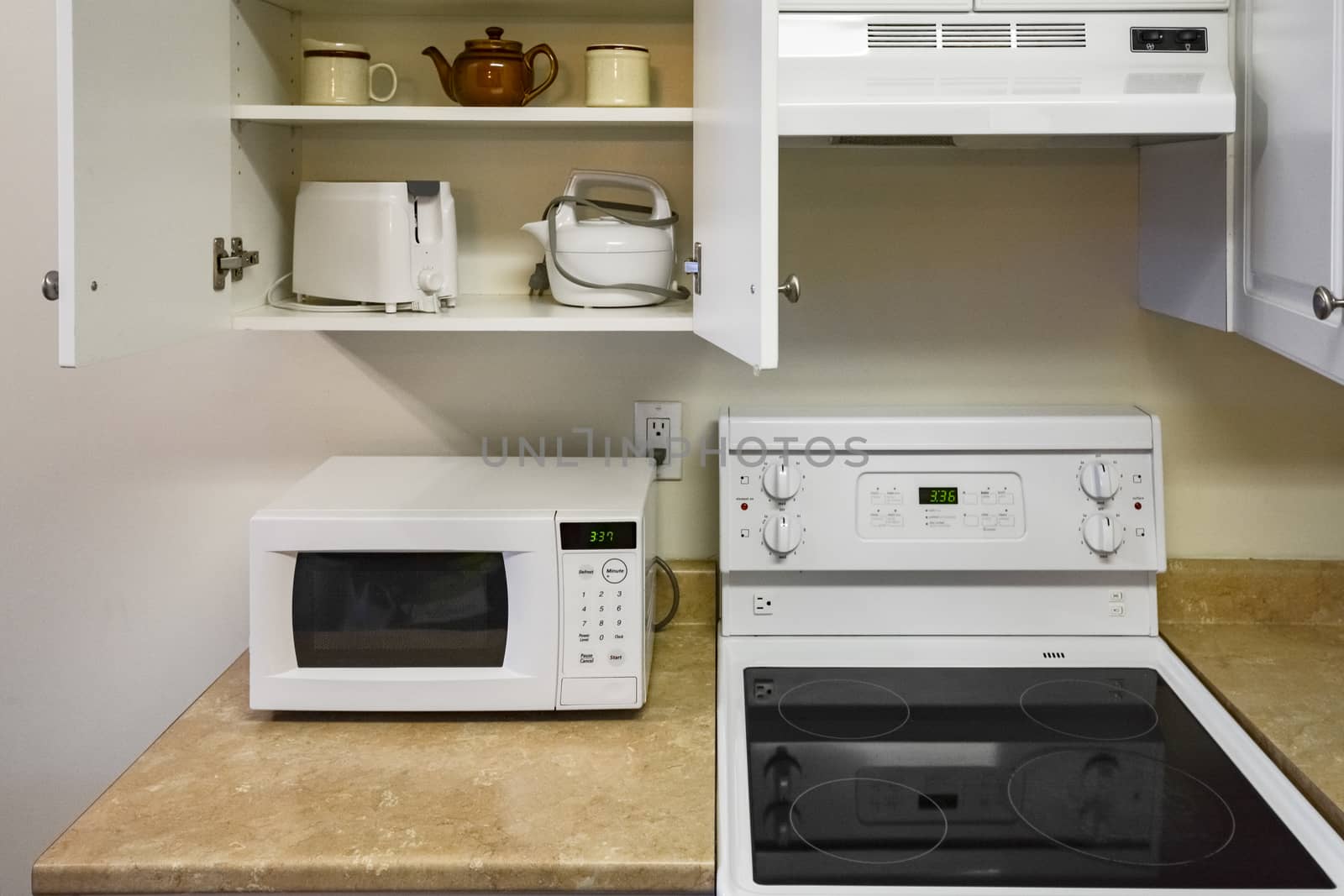 Open cabinets and primary appliances on average home kitchen