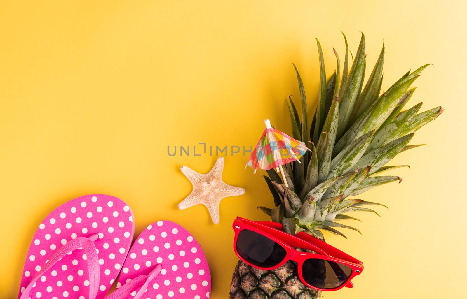 Celebrate Summer Pineapple Day Concept, Top view flat lay of funny fresh pineapple in sunglasses with starfish and slipper, in studio isolated on yellow background, Holiday summertime in tropical