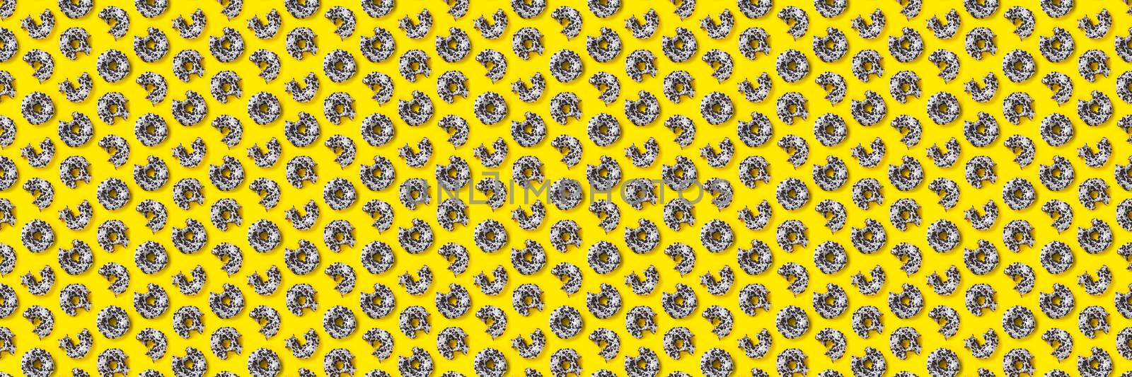 donuts on a yellow background top view. Flat lay of delicious nibbled chocolate donuts. used as donut banner or poster background, not pattern. by PhotoTime