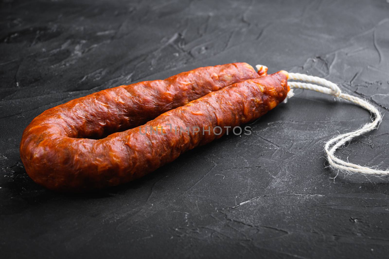 Traditional chorizo sausages on black background.