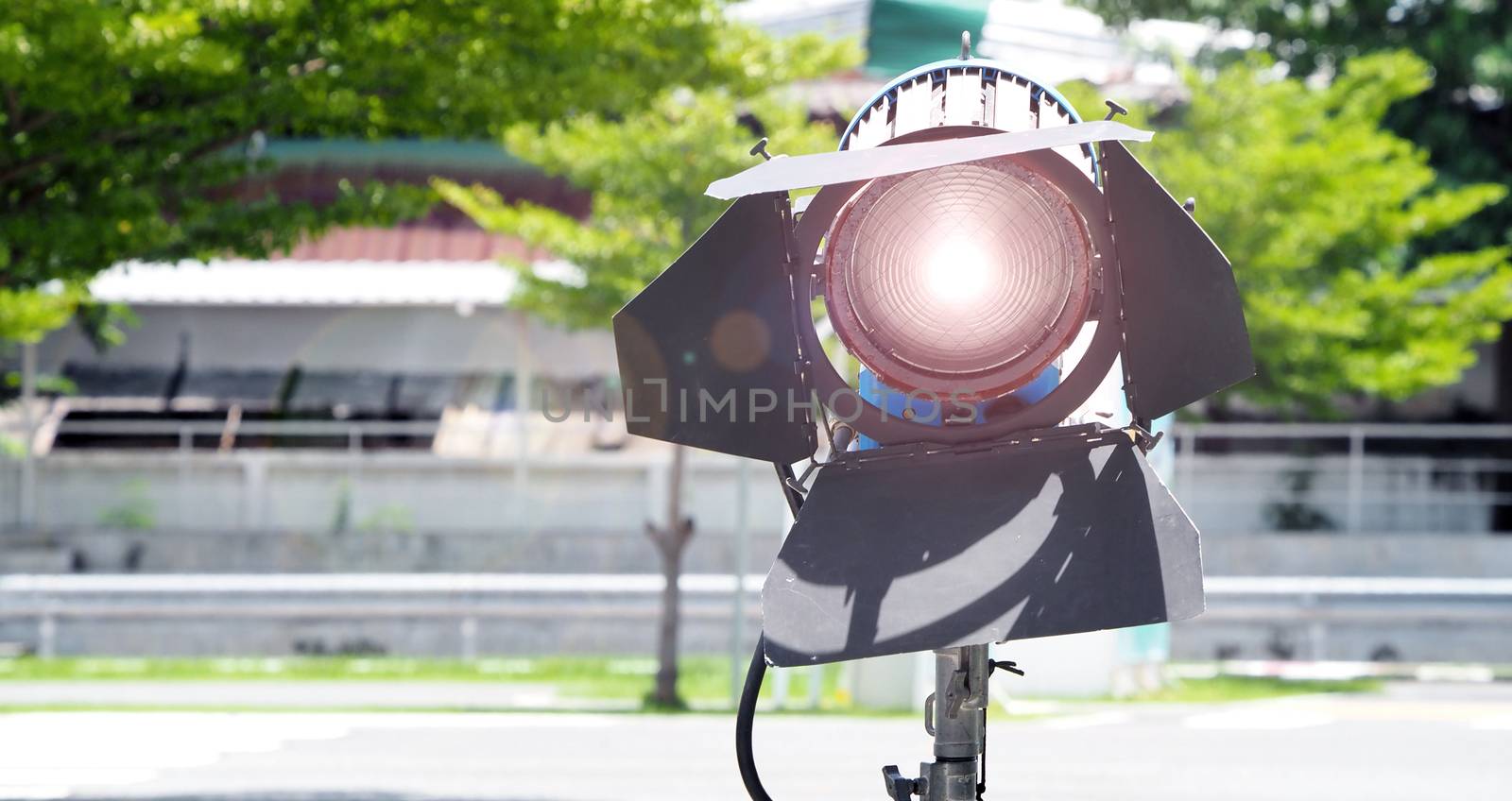 Big studio lighting with tripod for video production and outdoor location movie shooting.