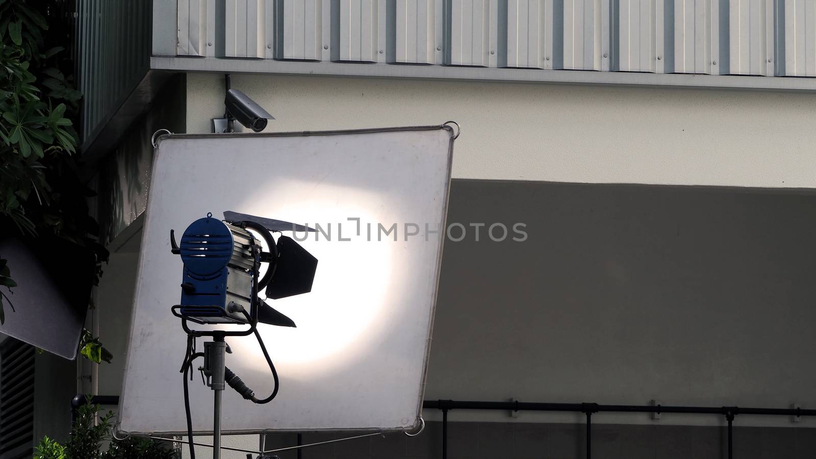 Big studio lighting with tripod for video production and outdoor location movie shooting.