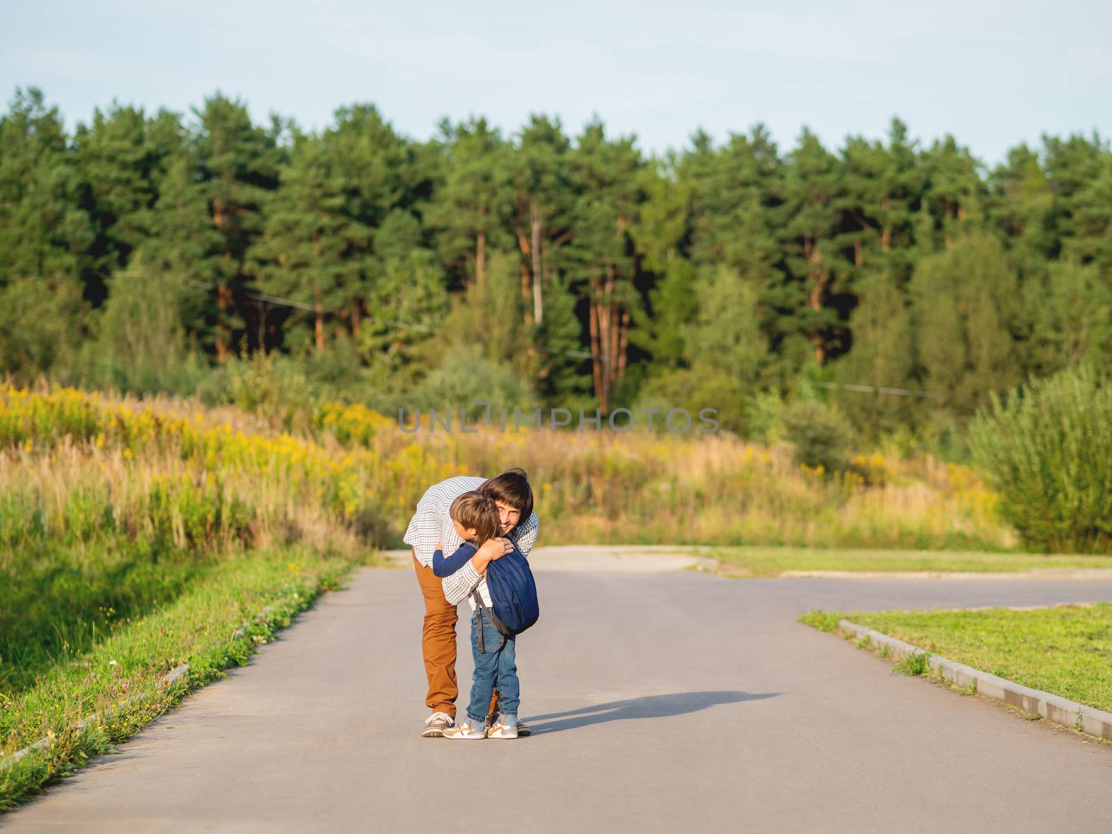 Father picks up his son from kindergarten. Back to school after by aksenovko