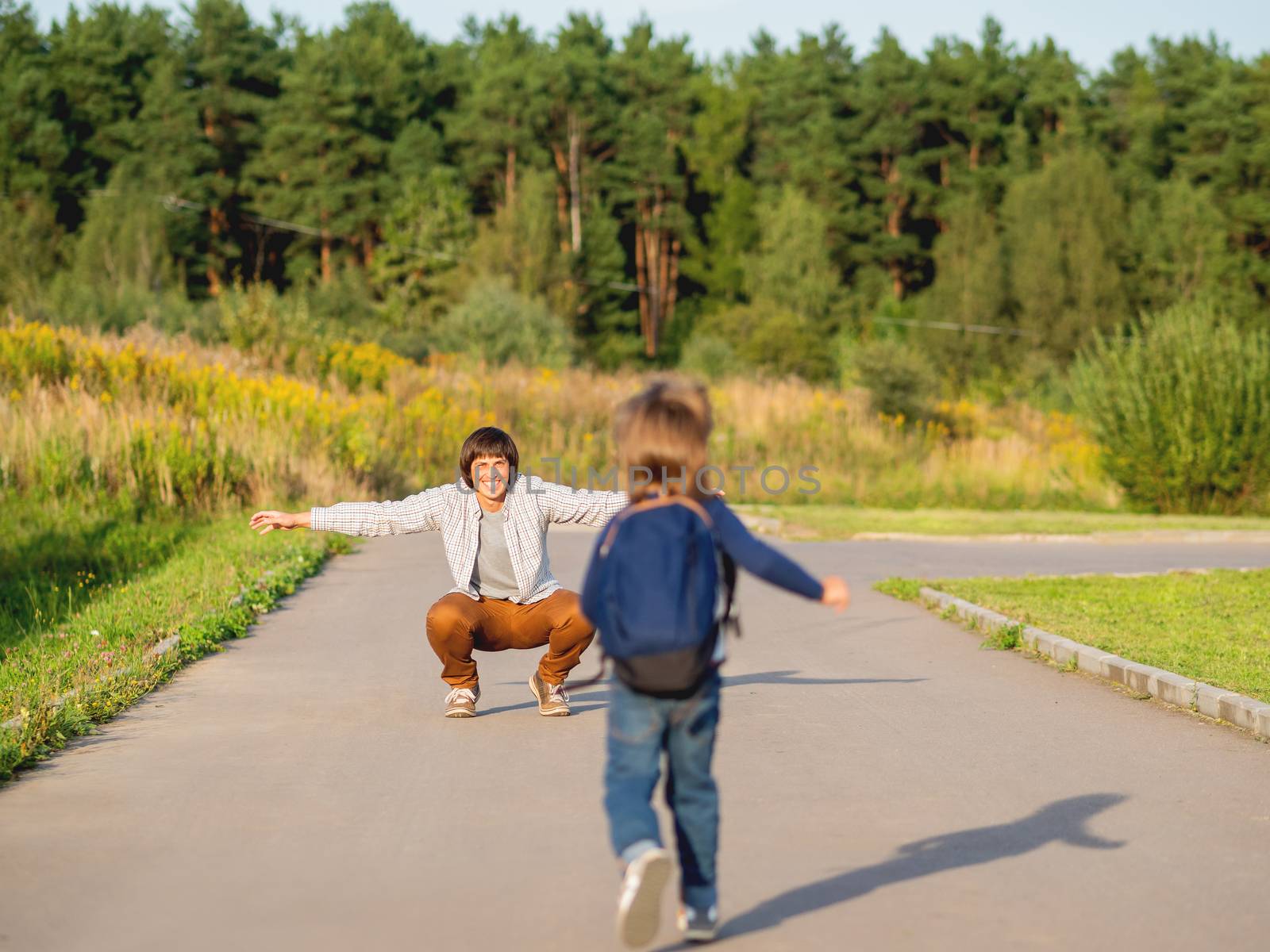 Father picks up his son from kindergarten. Back to school after by aksenovko