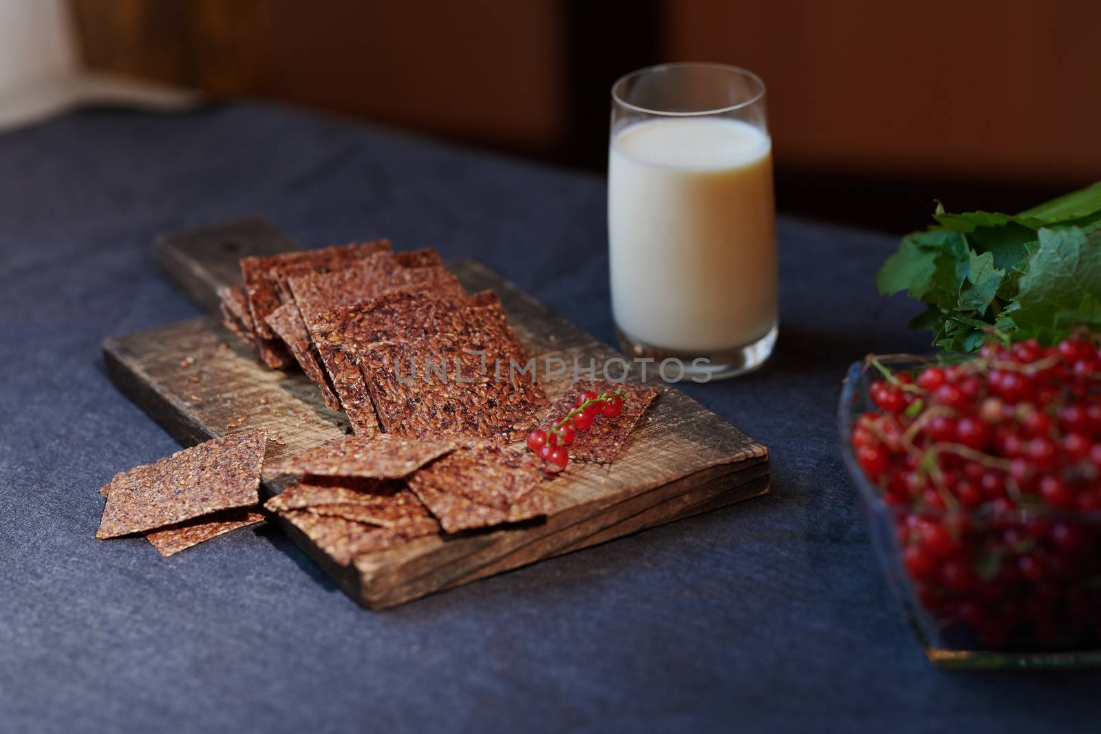 Vegan flaxseed bread with berries next to the glass with coconut by Novic