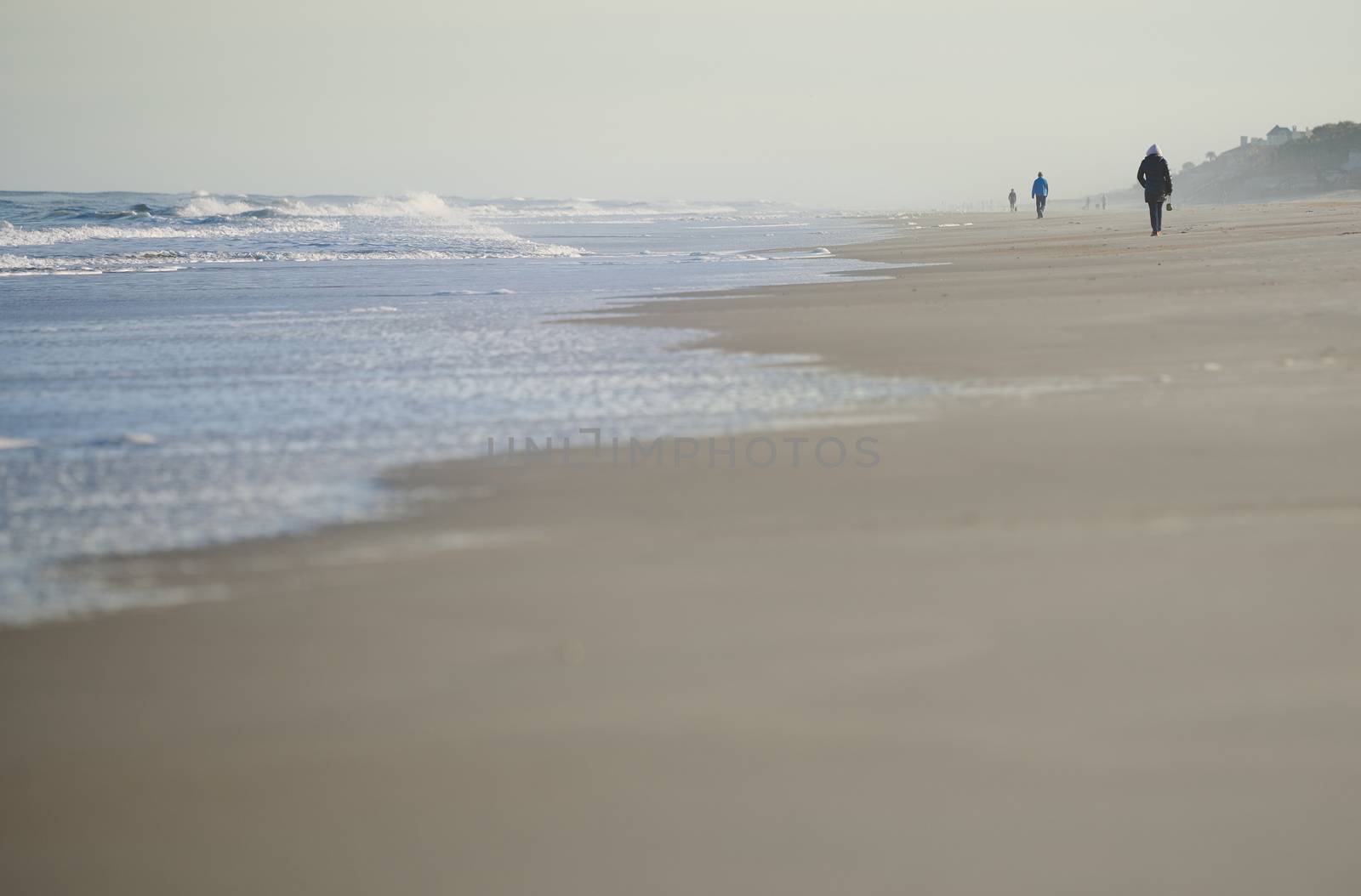 Incidental people walking along the beach of Atlantic Ocean. USA by Novic