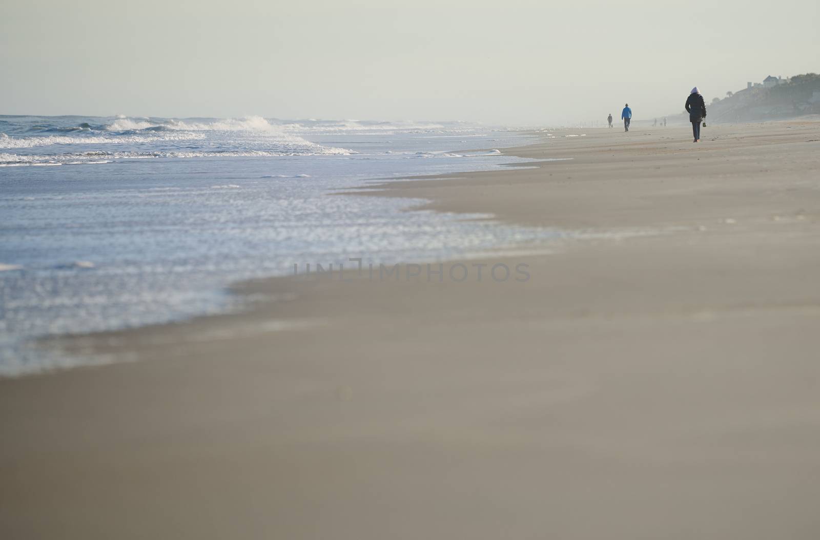 Incidental people walking along the beach of Atlantic Ocean. USA