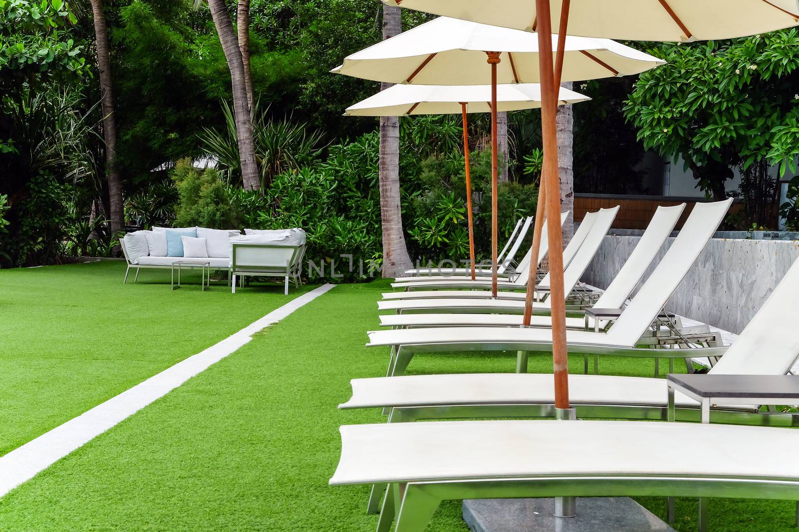 Image of Chaise longue at the pool in tropical resort