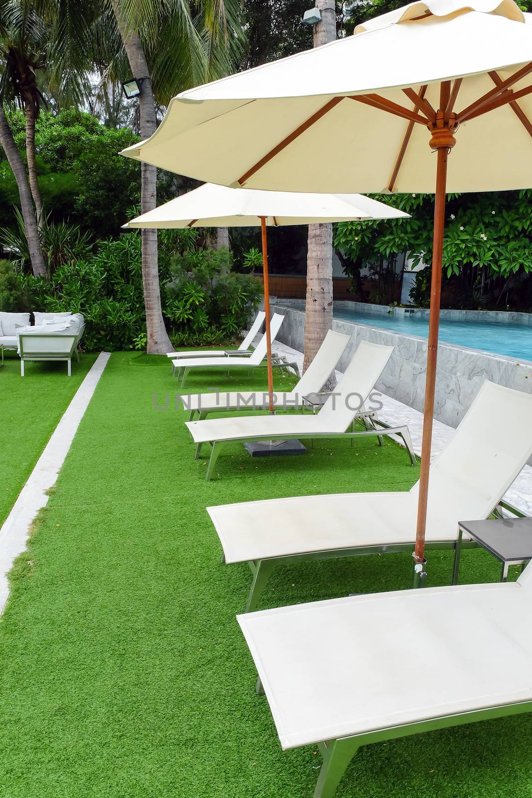 Image of Chaise longue at the pool in tropical resort