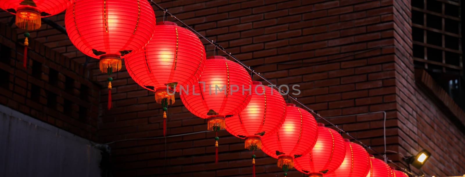 Beautiful round red lantern hanging on old traditional street, concept of Chinese lunar new year festival in Taiwan, close up. The undering word means blessing.