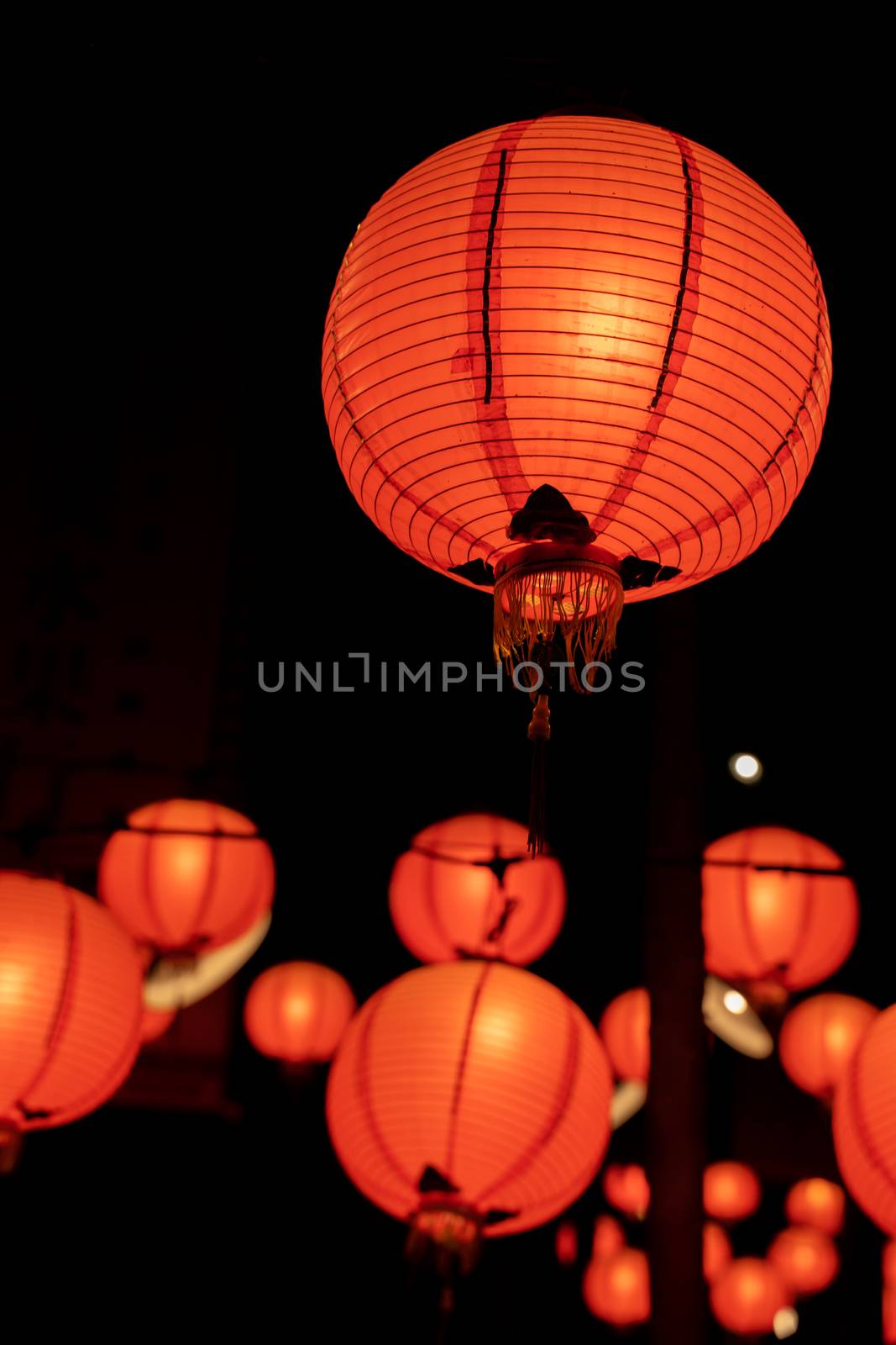 Beautiful round red lantern hanging on old traditional street, concept of Chinese lunar new year festival in Taiwan, close up. The undering word means blessing.