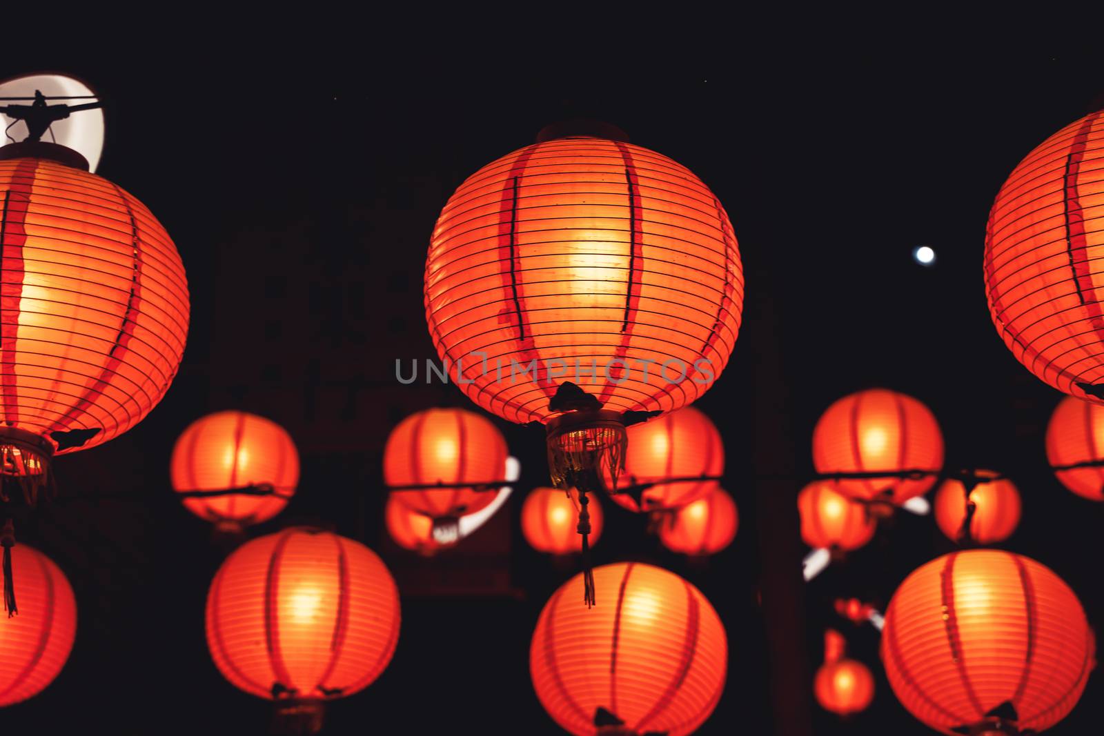 Beautiful round red lantern hanging on old traditional street, concept of Chinese lunar new year festival in Taiwan, close up. The undering word means blessing.