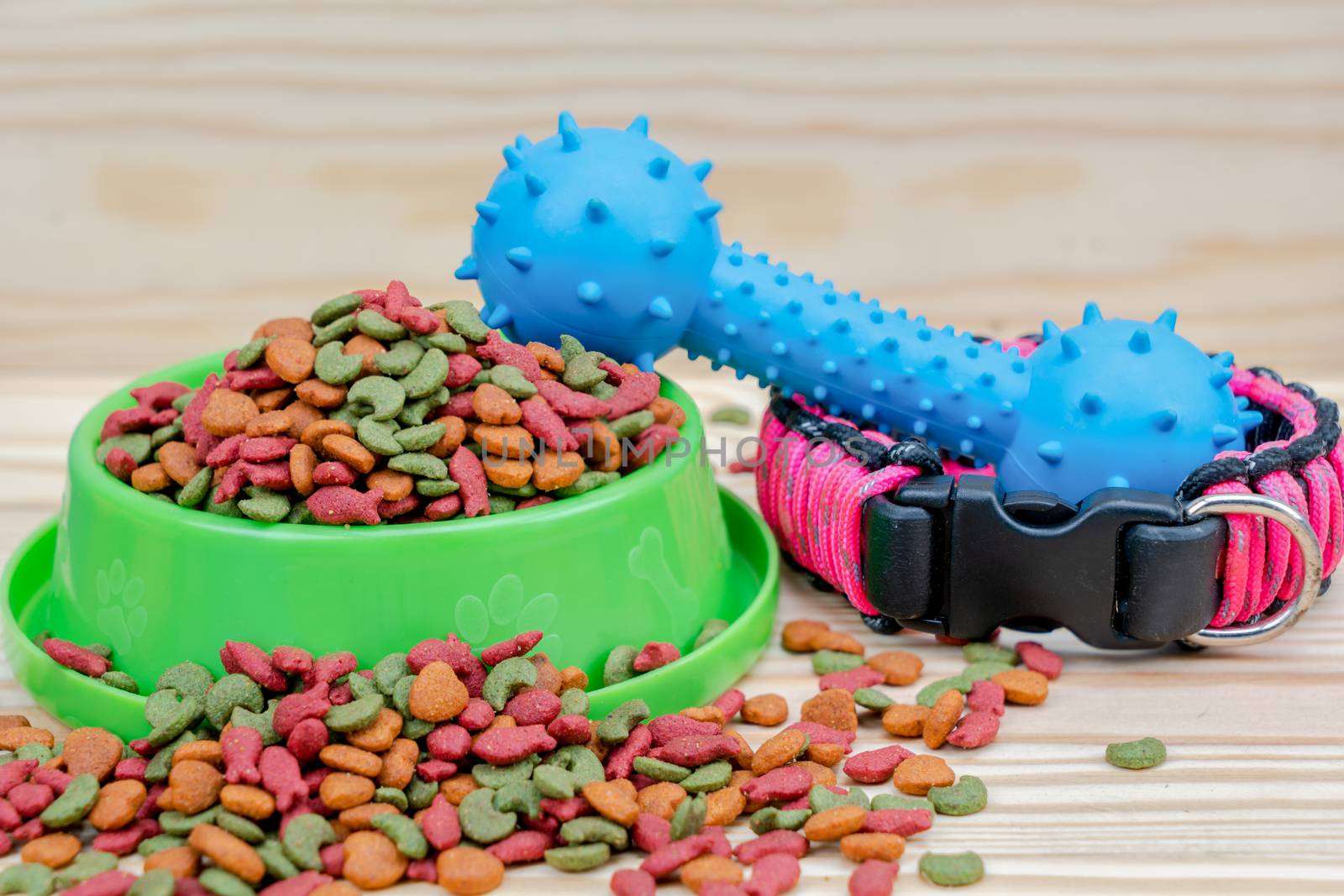 Pet food with rubber toy on wooden background by Buttus_casso