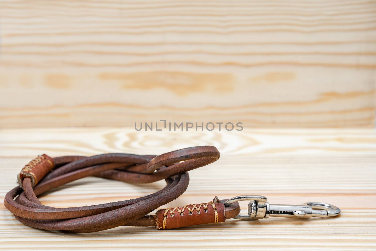 Pet leather leashes on wooden background by Buttus_casso