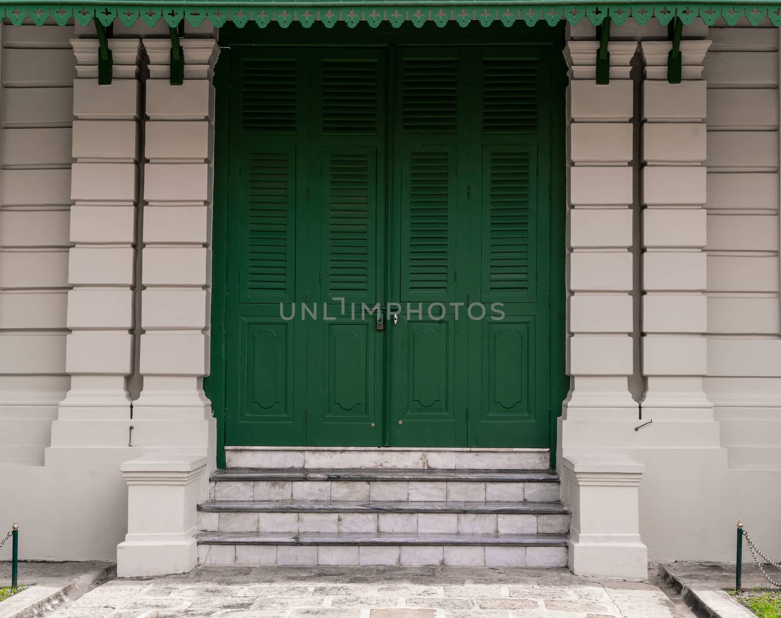 Green door with brick for background