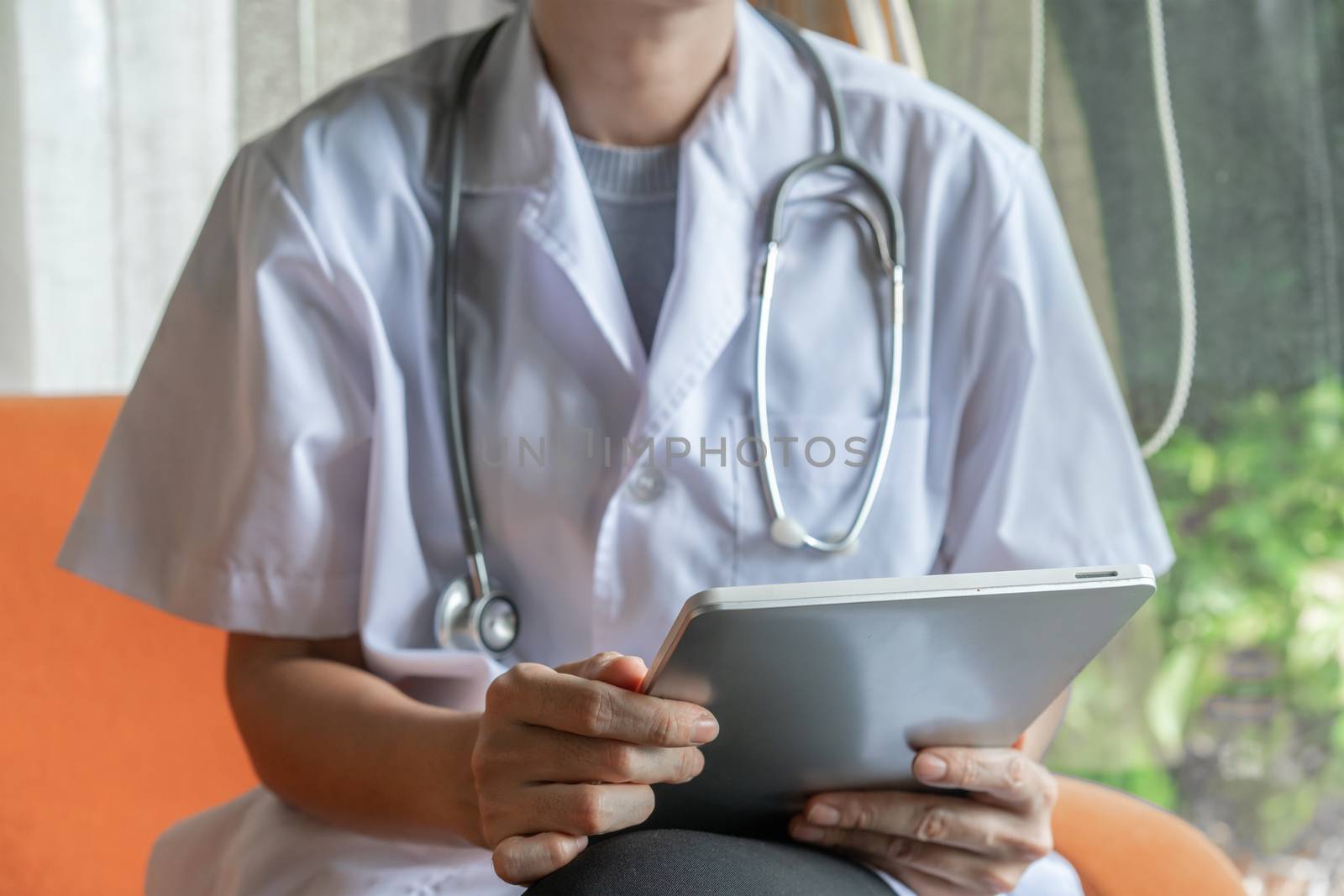 Doctor holding tablet in telemedical concept