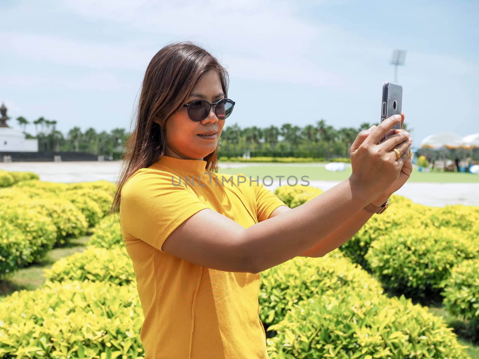 Asian woman standing selfie In tourist places by Unimages2527