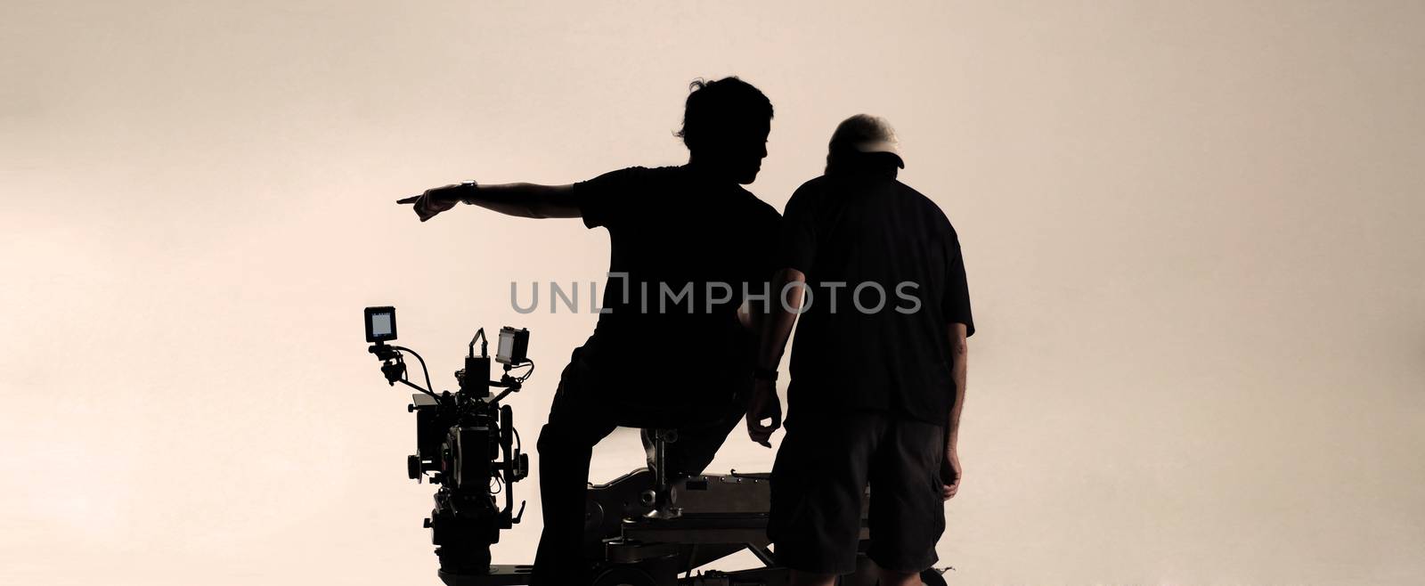 Silhouette behind the scenes of camera man. by gnepphoto