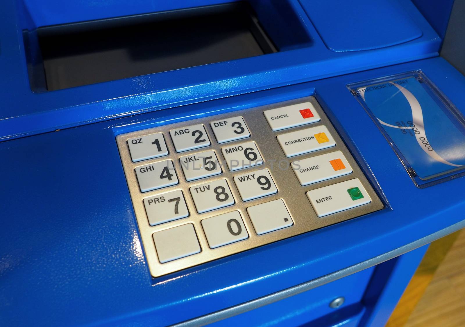 Blue color ATM machine and white button keypad. by gnepphoto