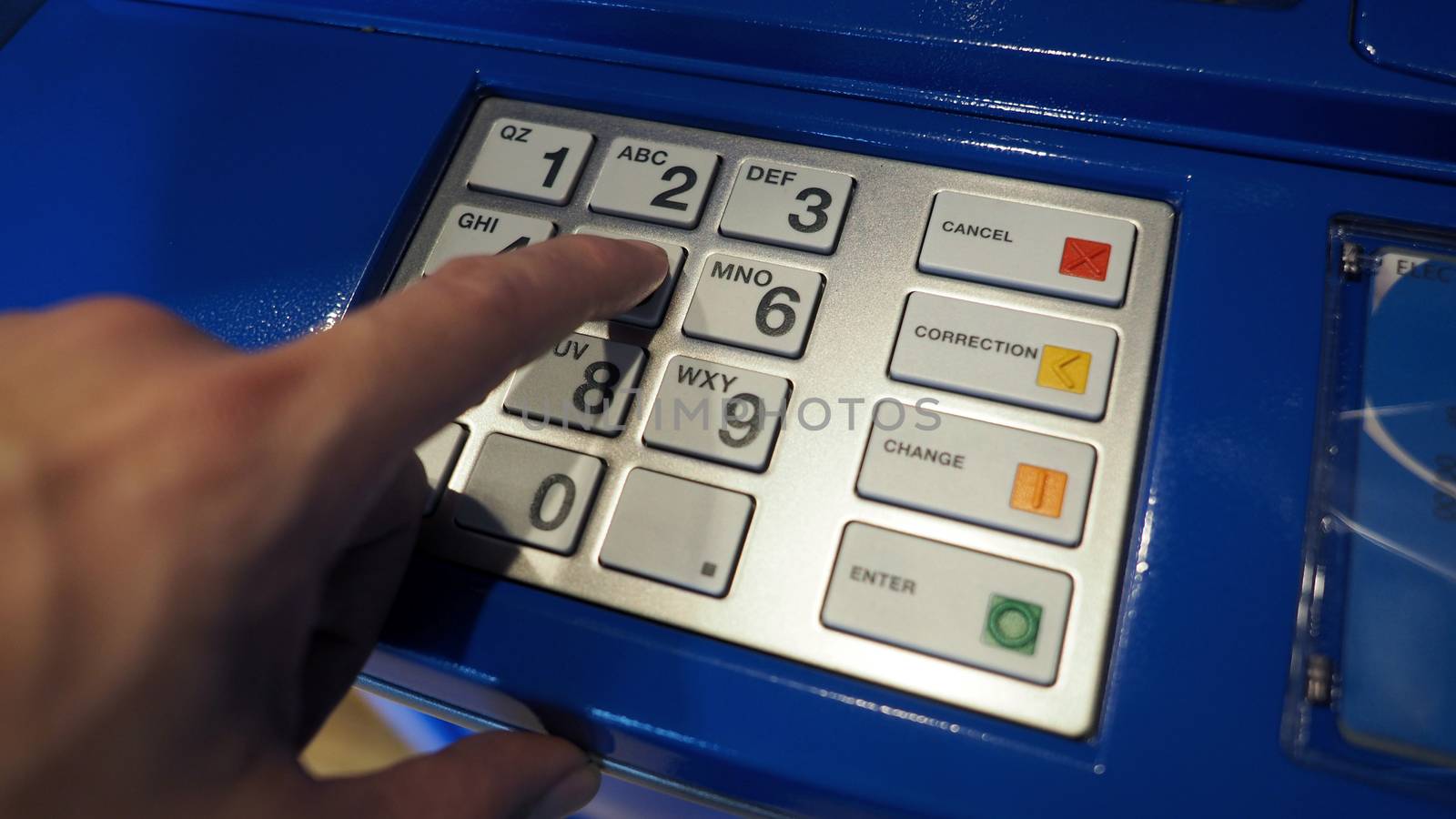 Blue color ATM machine and white button keypad. by gnepphoto