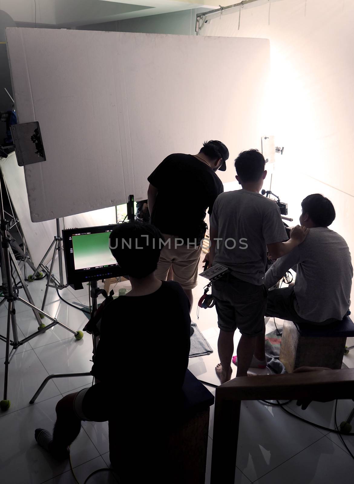 Silhouette film crew team shooting video commercial. by gnepphoto