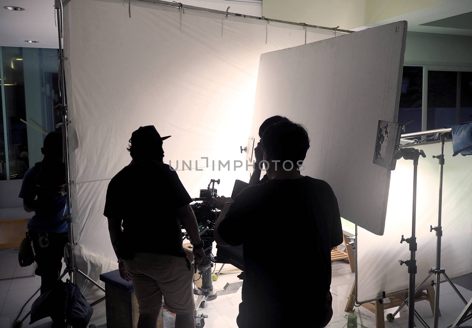 Silhouette film crew team shooting video commercial. by gnepphoto