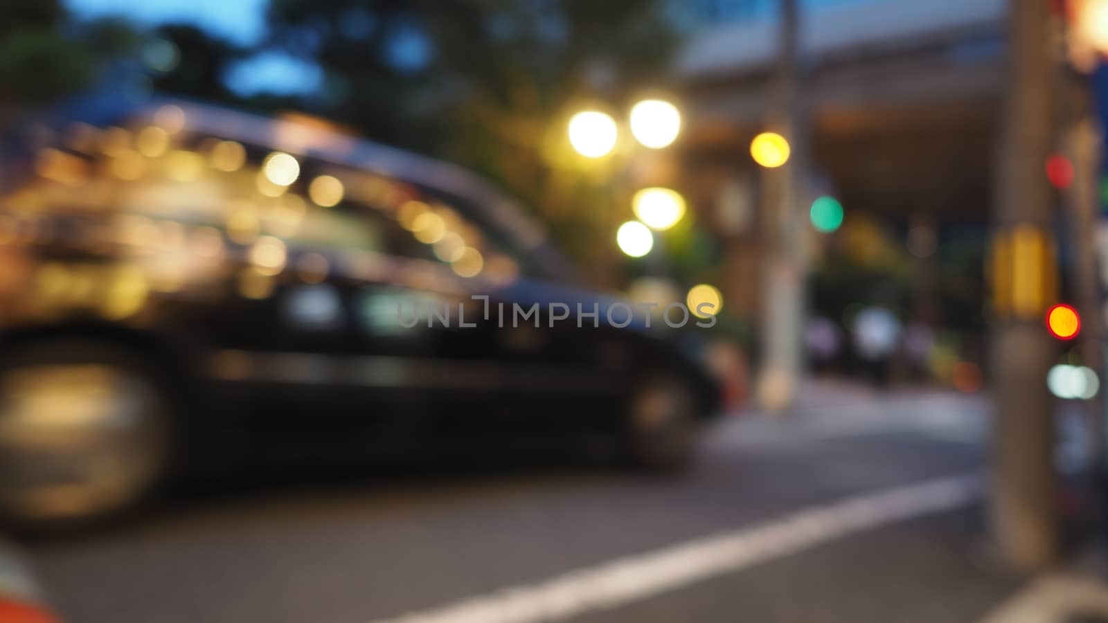 Blurry image of city street life in evening of Osaka Japan and colorful bokeh effect lights.