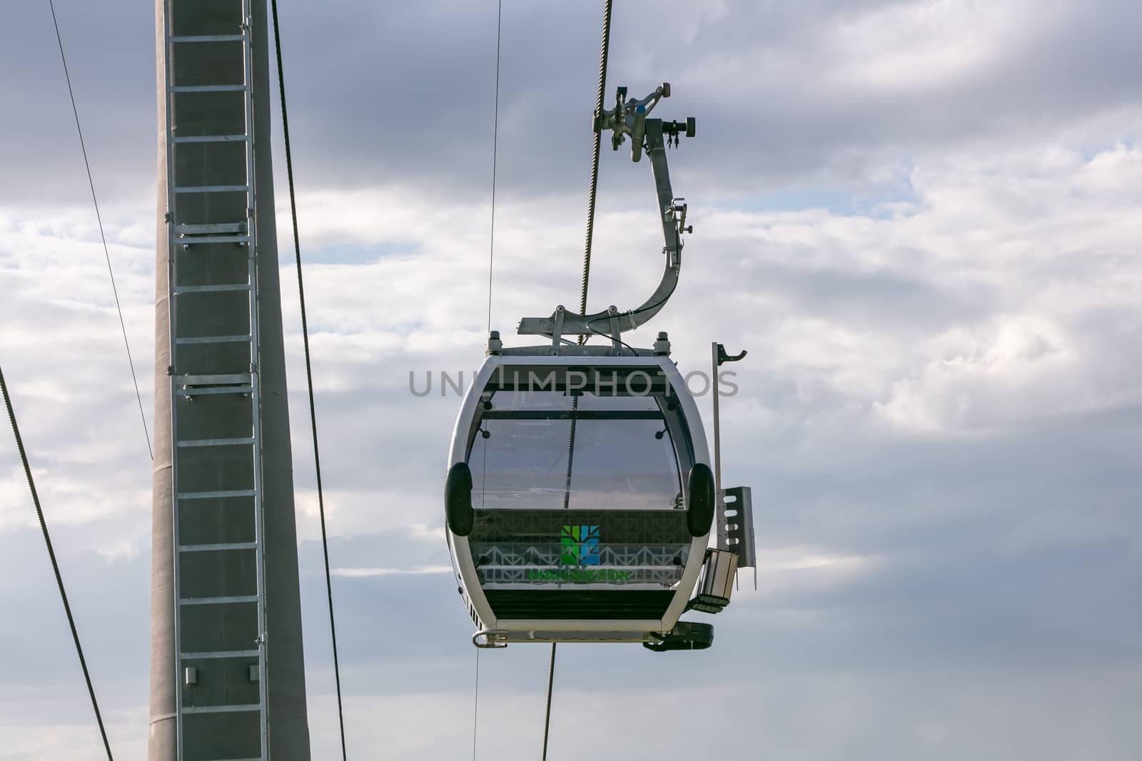 Manzherok resort, Altai Mountains, Russia - August 12, 2020: Low angle shot of cableway on a cloudy sky background