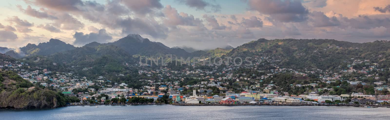Amazing aerial panoramic landscape shot of St. Vincent island in the Caribbean Sea. Beautiful sunset clouds and mountains in the background. High angle shot.