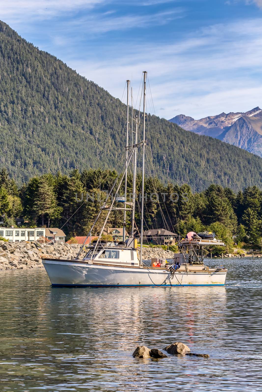 Shot of a fishing boat sailing in harbour in Sitka by DamantisZ