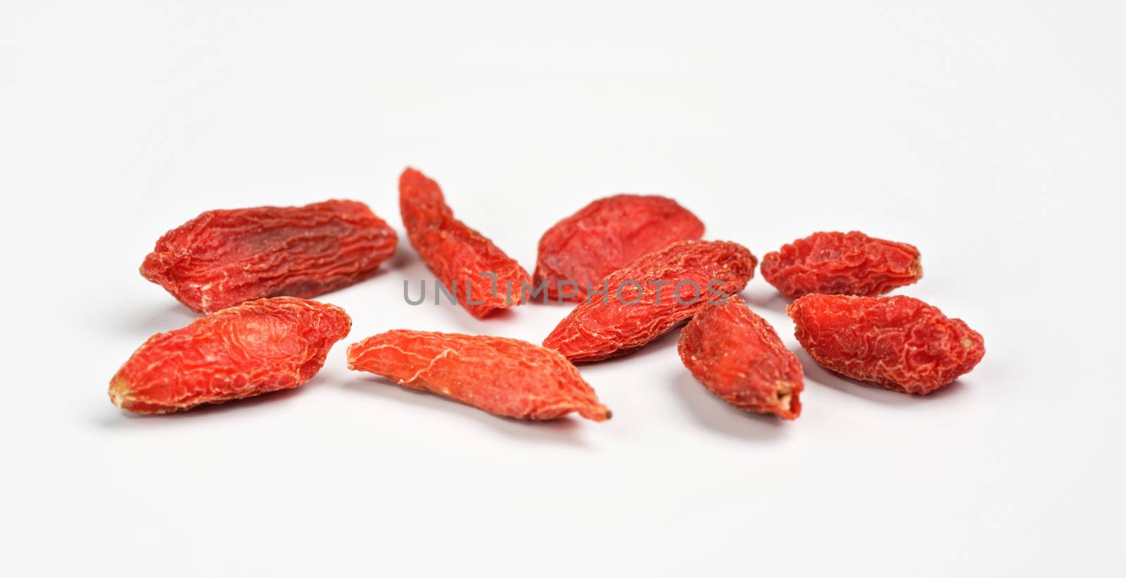 Closeup photo of goji berry wolfberry - Lycium chinense dried fruits isolated on white background.