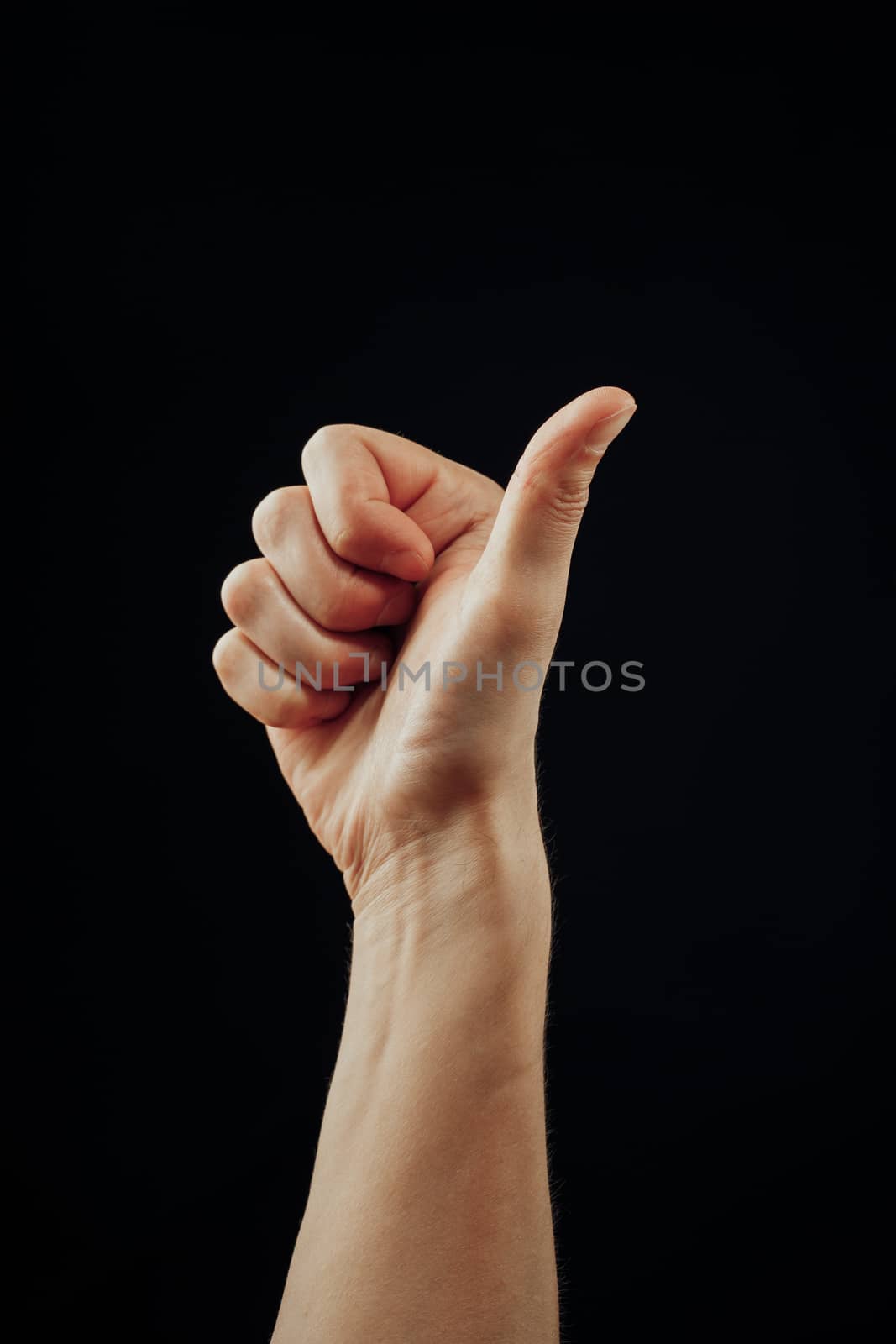 thumbs up male hand, isolated on black