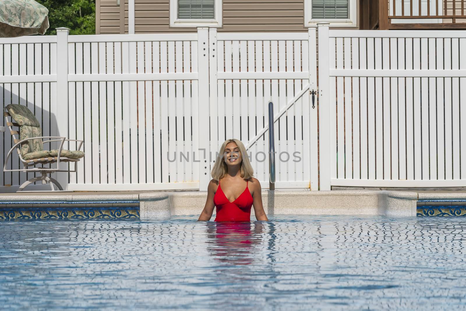 A gorgeous young blonde model poses in a bikini while enjoying a summers day
