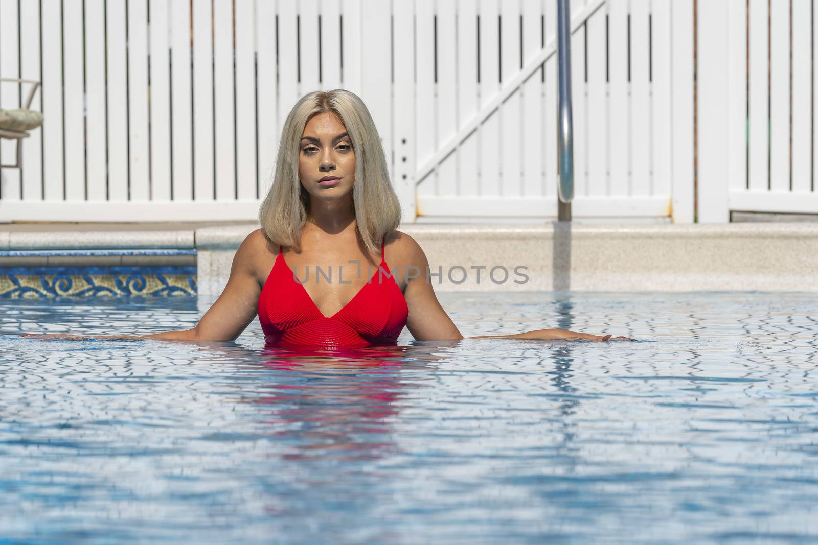 A gorgeous young blonde model poses in a bikini while enjoying a summers day