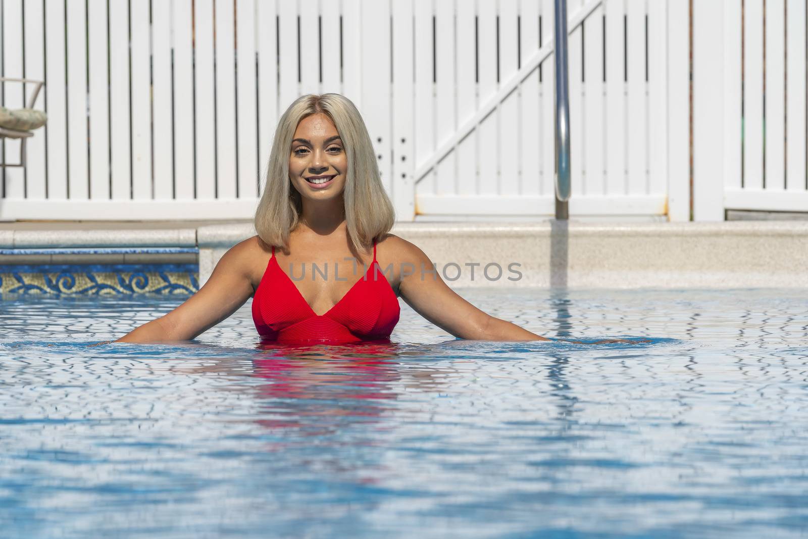 A gorgeous young blonde model poses in a bikini while enjoying a summers day