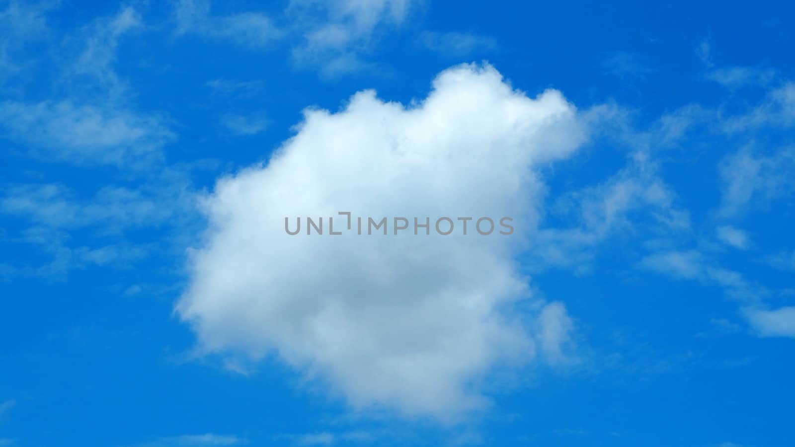 Big white cloud on the blue sky in summer clear day.