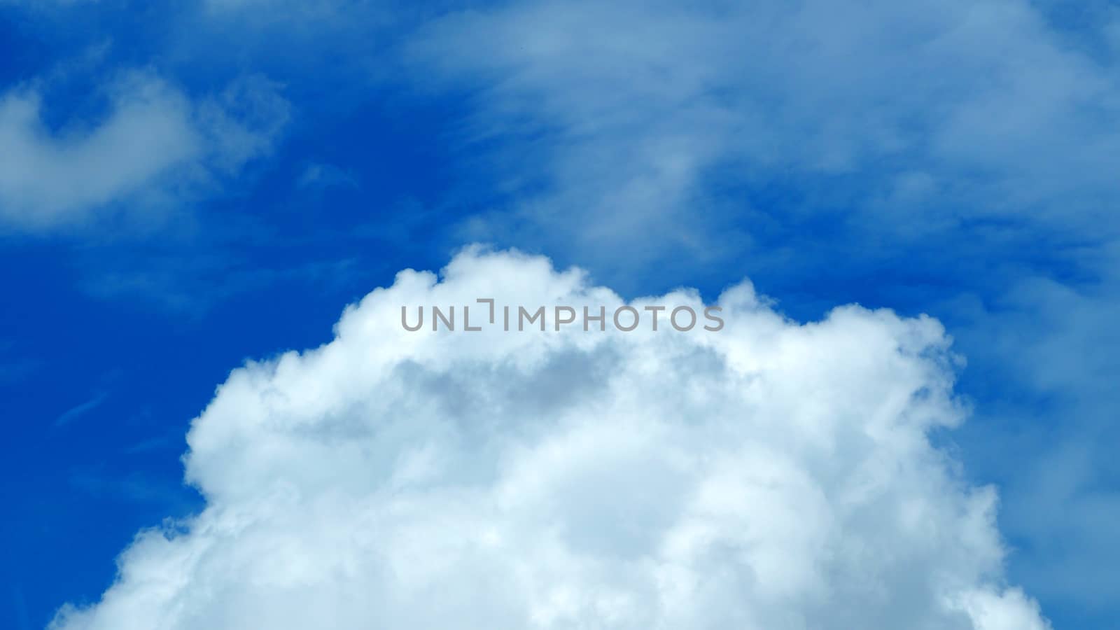 Big white cloud on the blue sky in summer clear day.