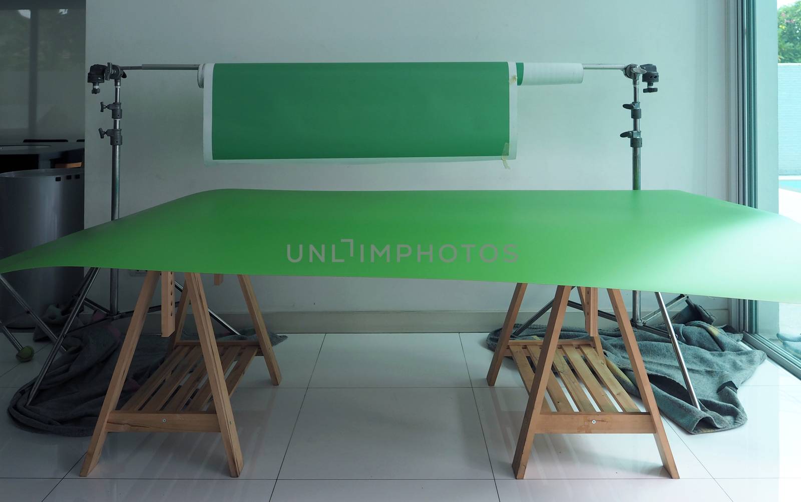Green screen paper backdrop and tripod. by gnepphoto