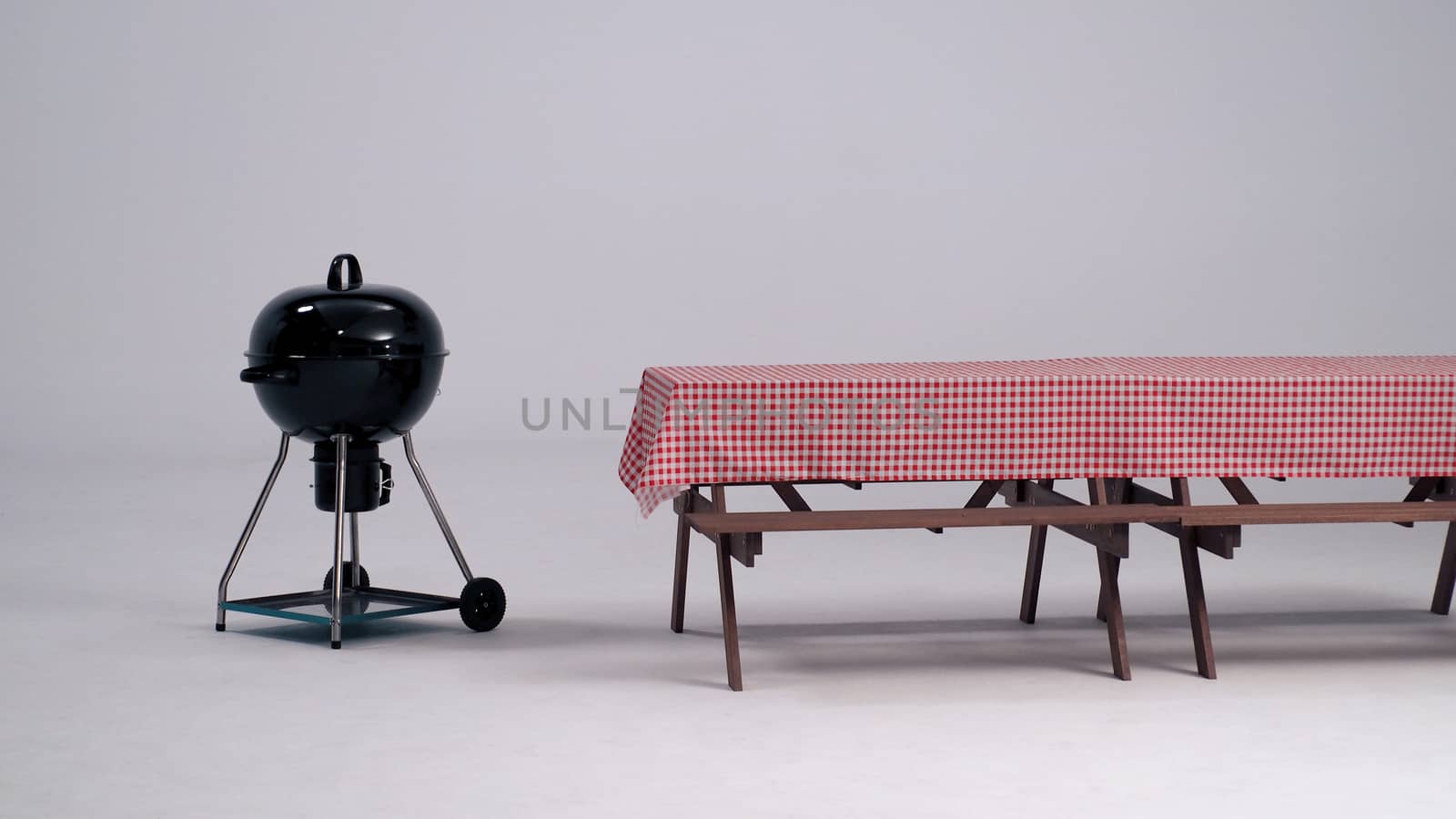 Table with red napkin and BBQ stove. by gnepphoto