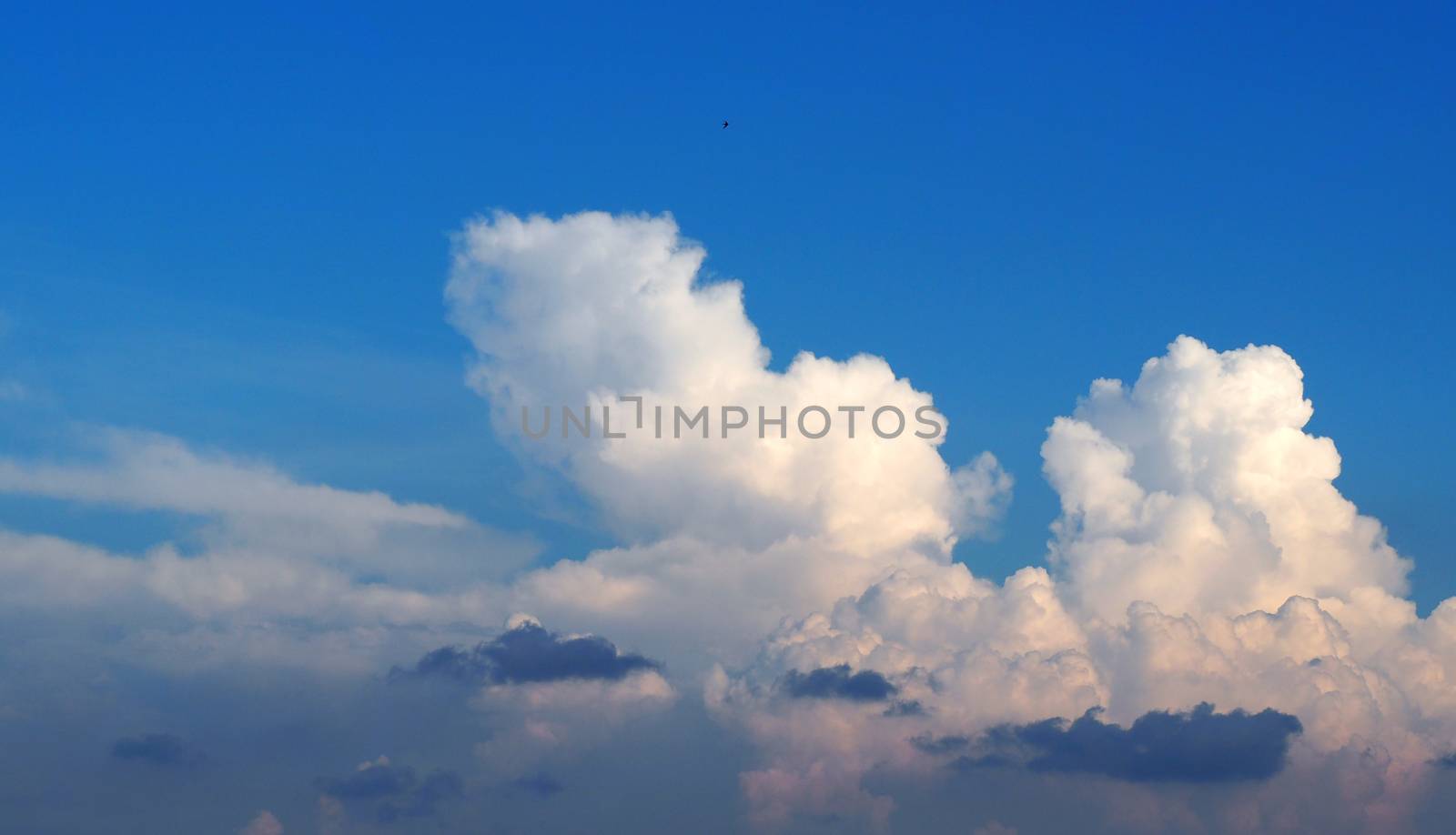 Blue sky and white clouds over the city in good weather summer day.