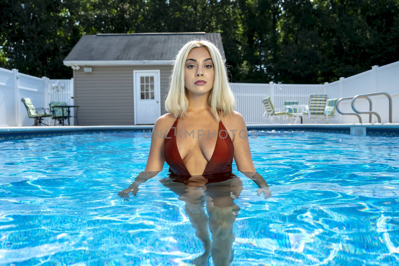 A gorgeous young blonde model poses in a bikini while enjoying a summers day