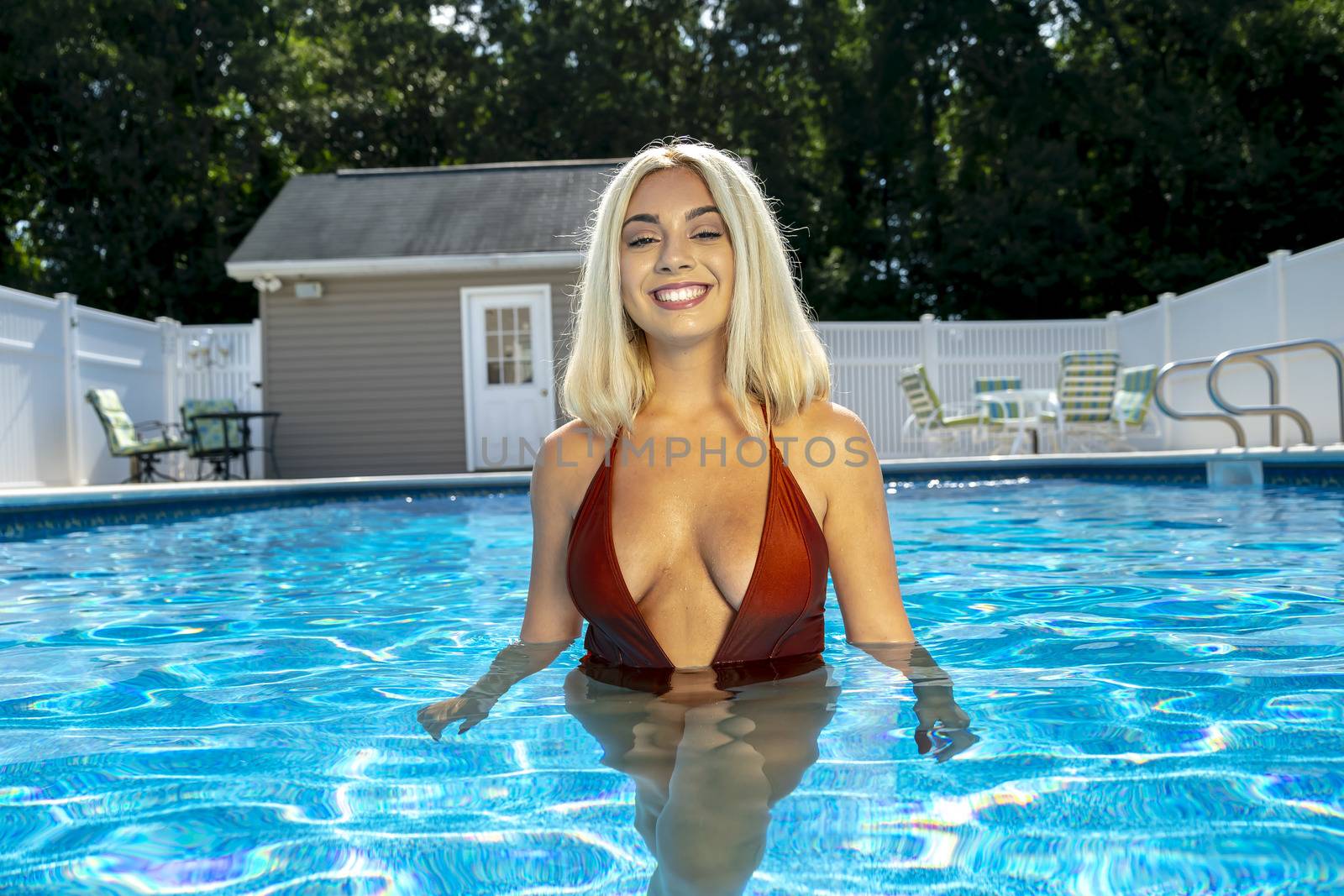 A gorgeous young blonde model poses in a bikini while enjoying a summers day