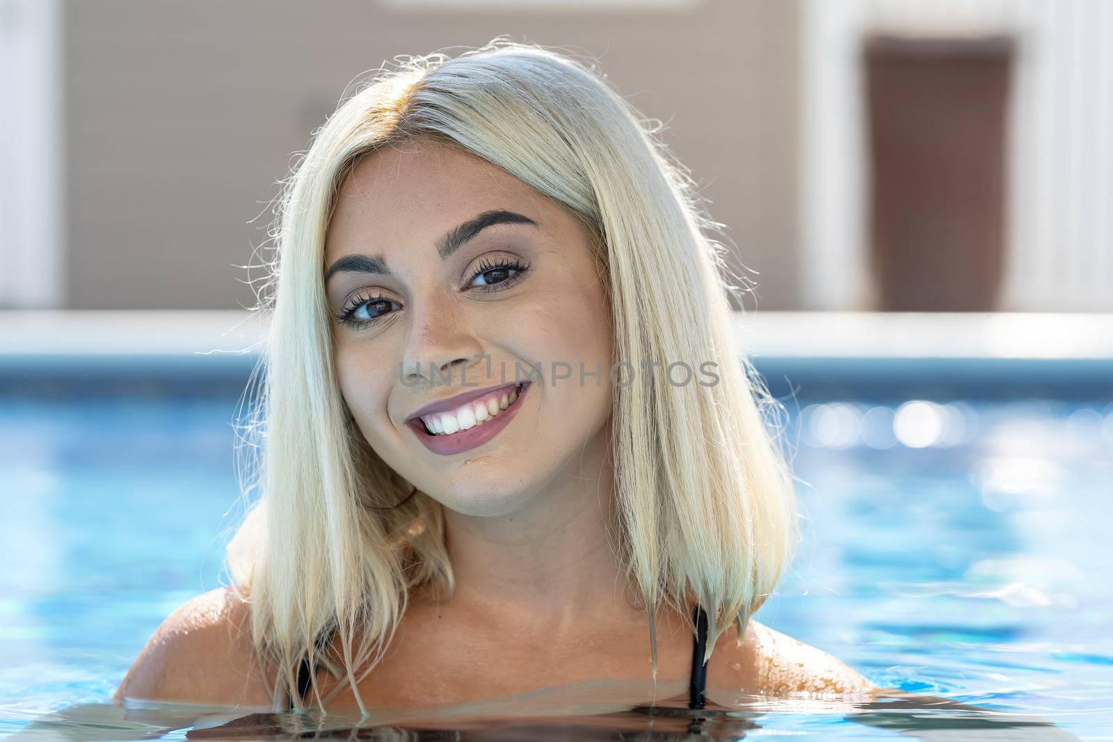A gorgeous young blonde model poses in a bikini while enjoying a summers day