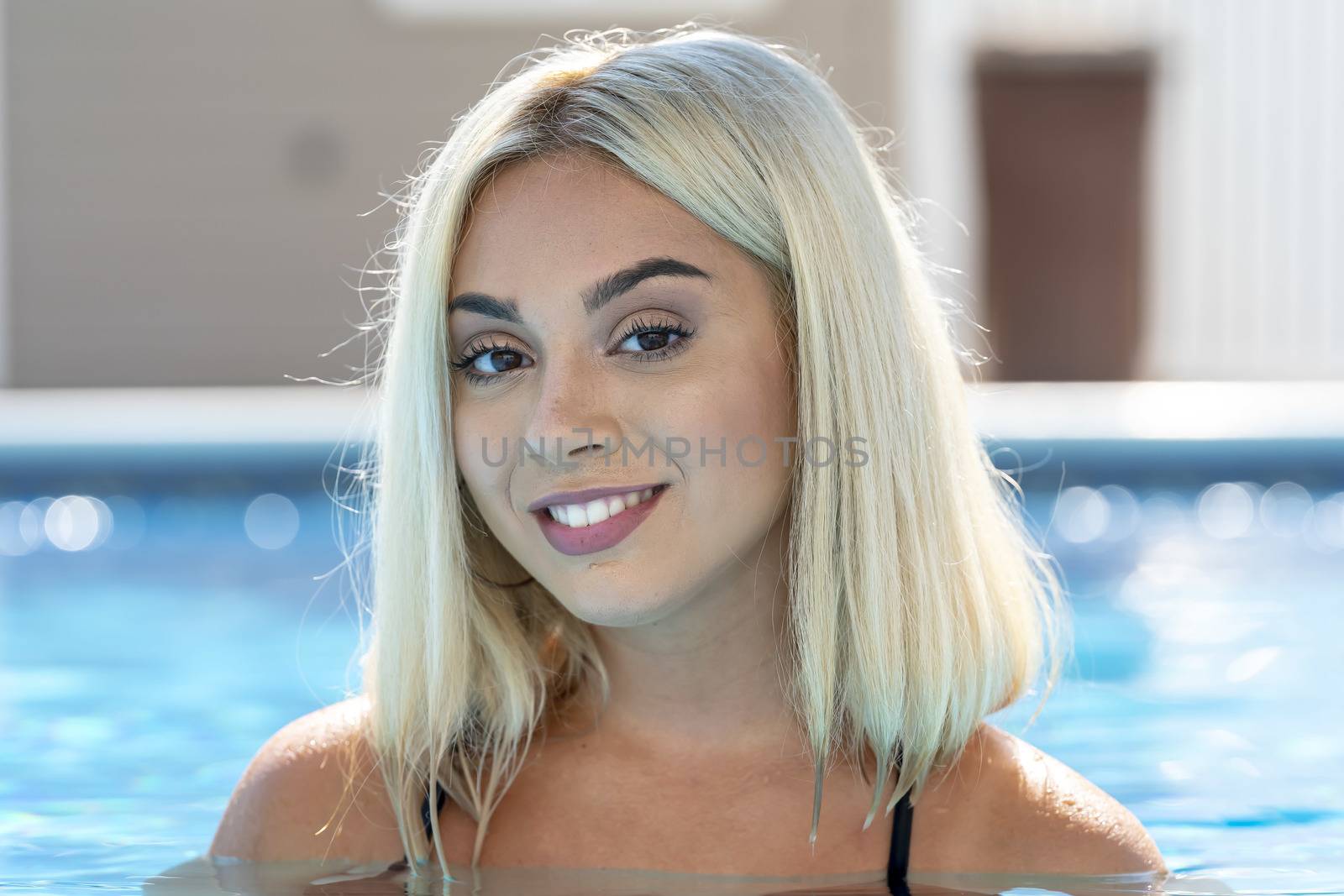 A gorgeous young blonde model poses in a bikini while enjoying a summers day