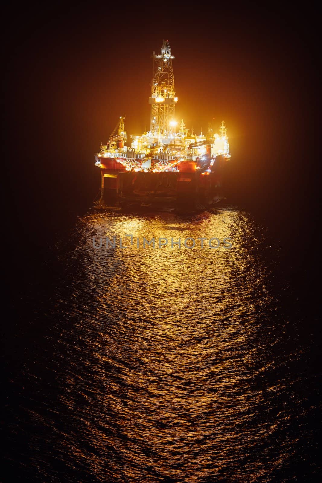 offshore oil platform at night by nikkytok