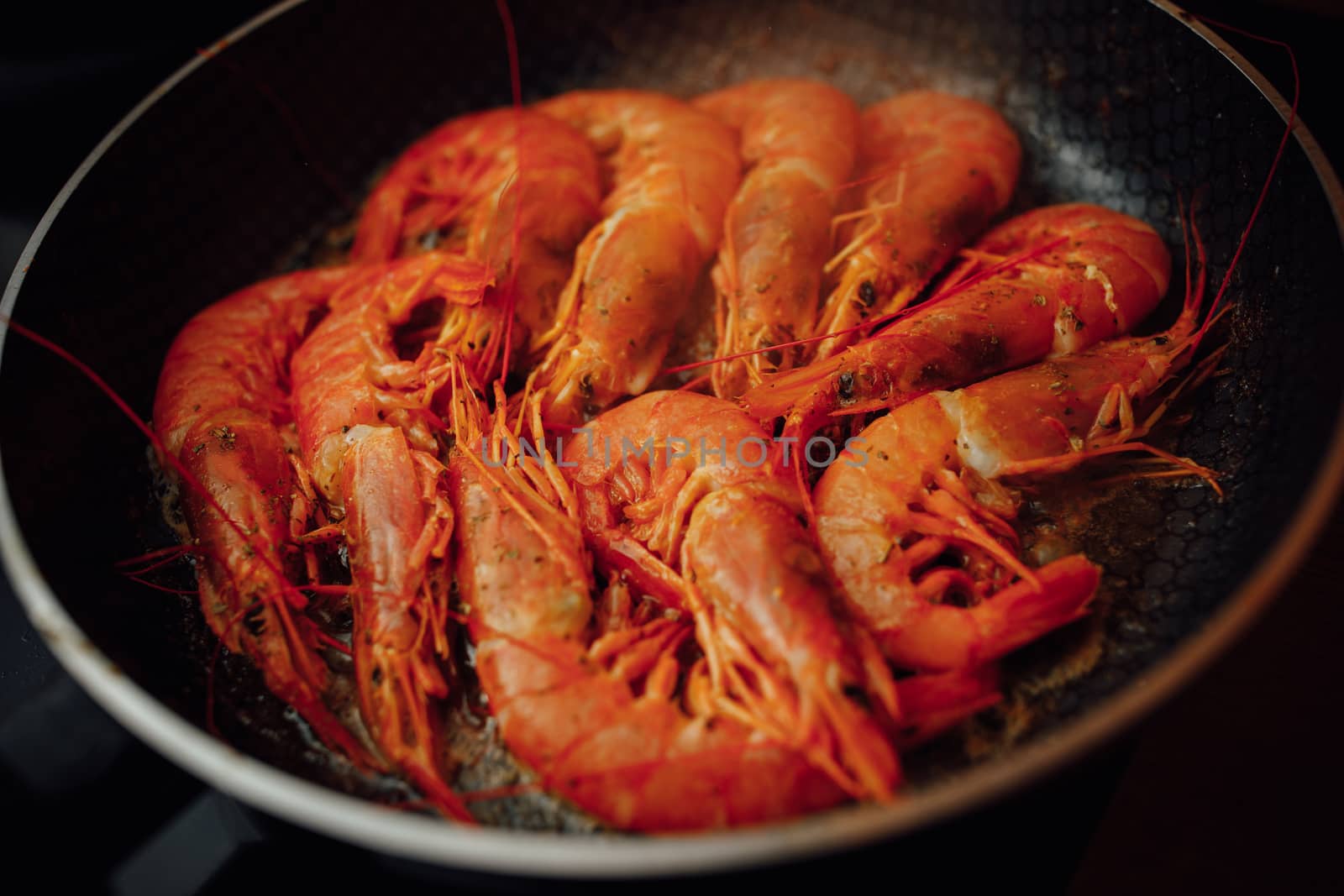 fried red shrimps with hot oil on pan