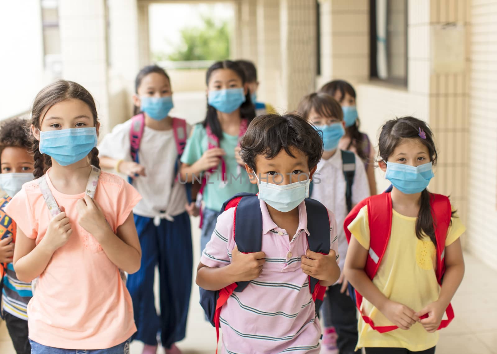 children wearing face medical mask back to school after covid-19 quarantine by tomwang