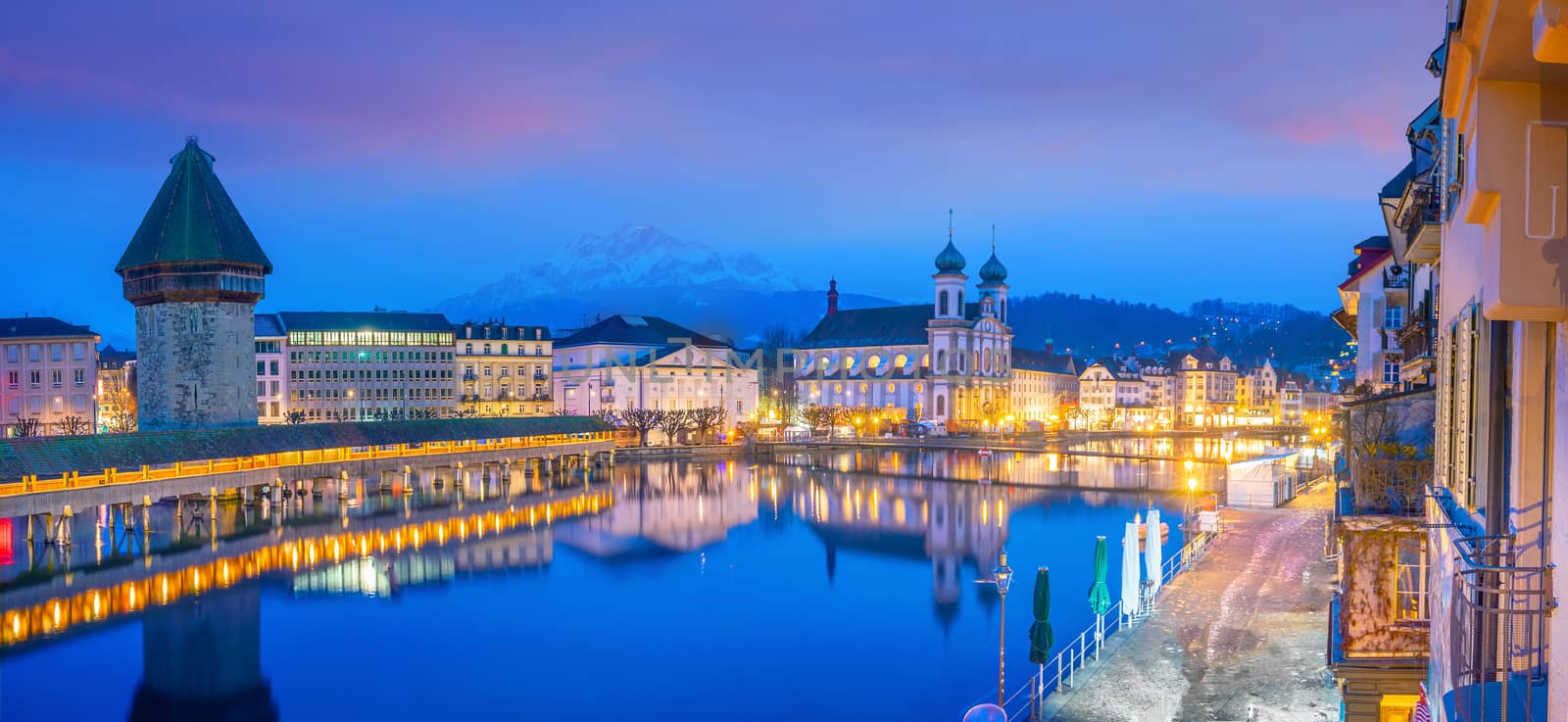 Historic city center of downtown Lucerne with  Chapel Bridge and lake Lucerne in Switzerland at sunset